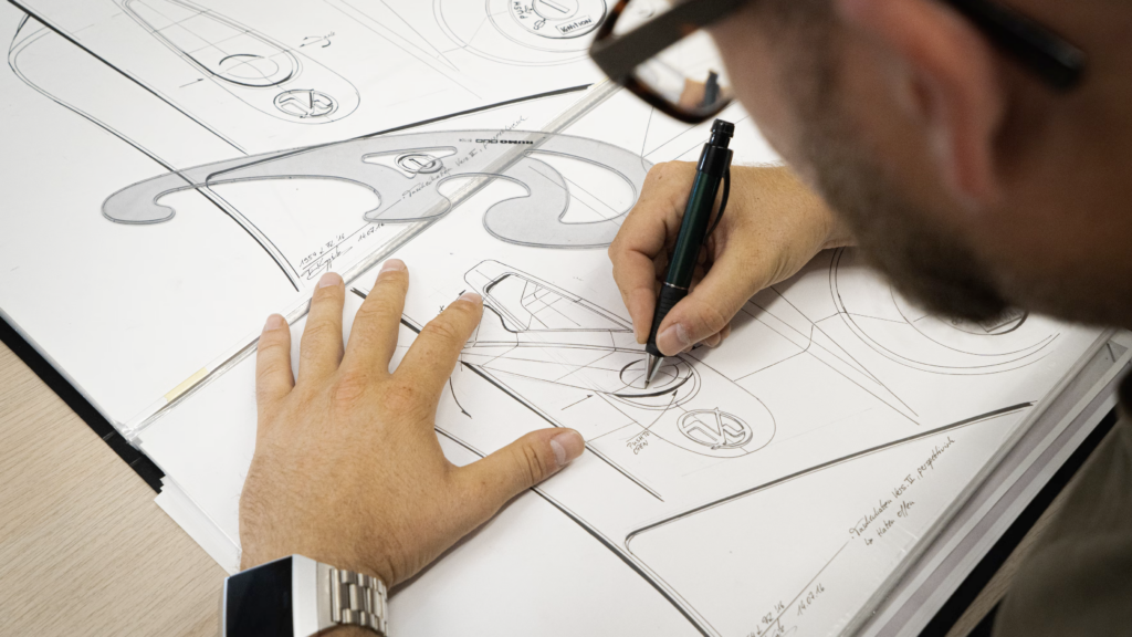 Photo of a man working on a technical design drawing